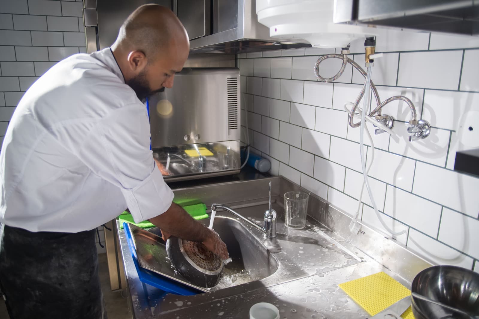 Cleaning a cast iron skillet at the sink