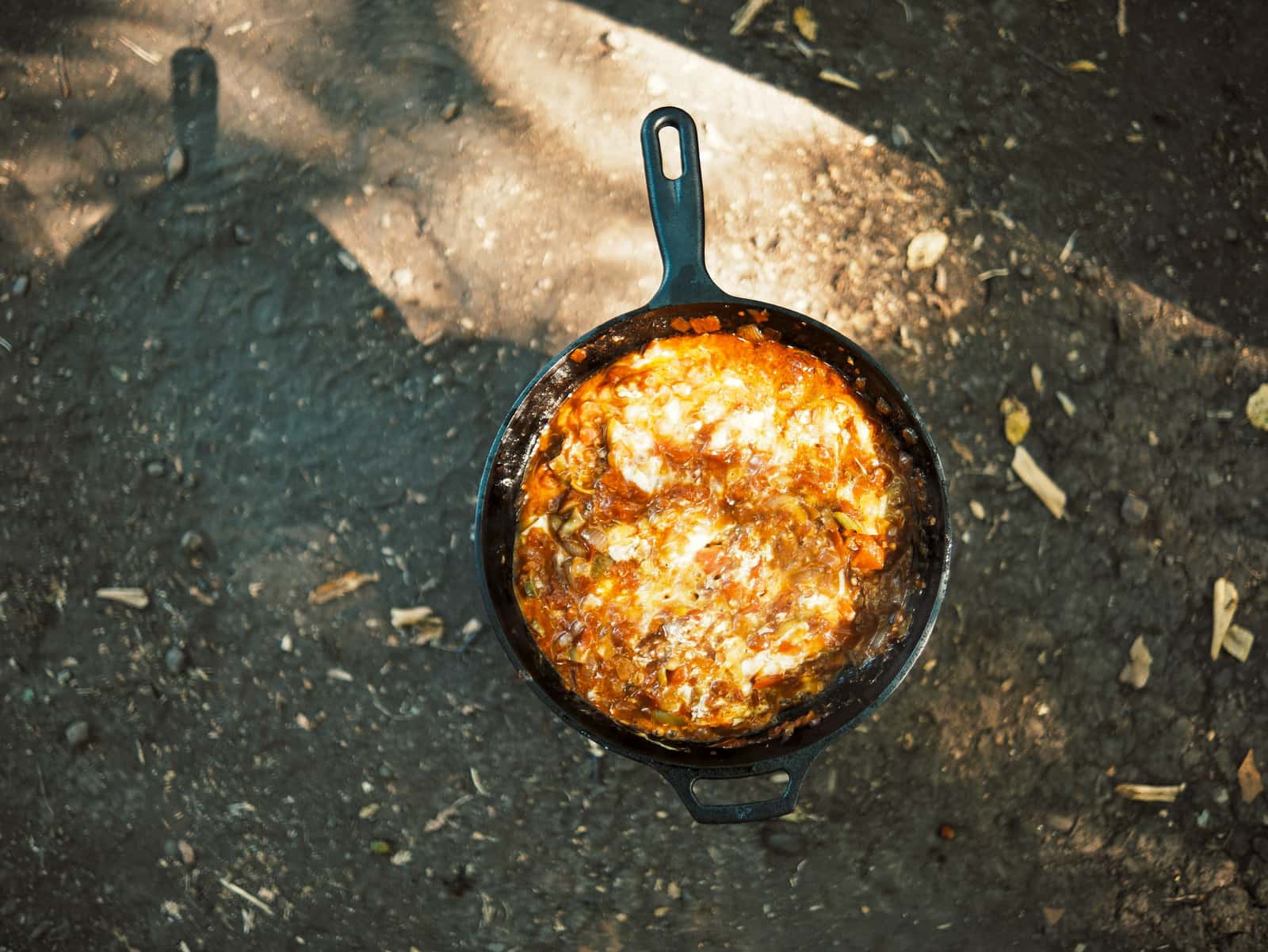 A pizza baked in a cast iron pan